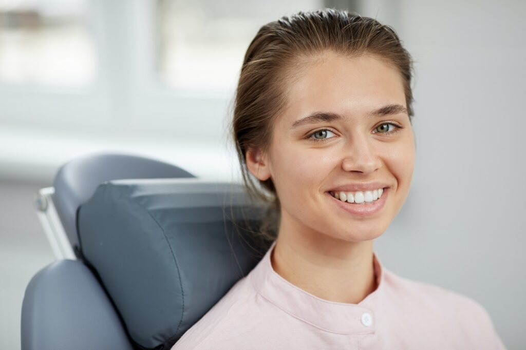 Smiling Young Woman in Dental Chair