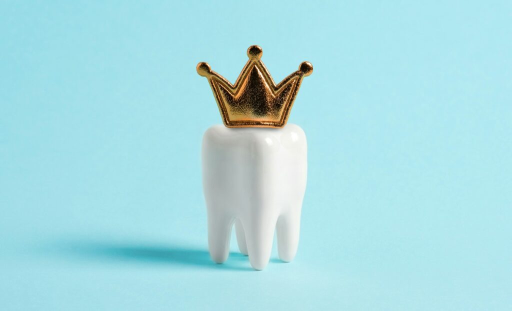 Golden dental crown on a tooth model highlighting advanced crown technology at Dental Professionals of Dardenne